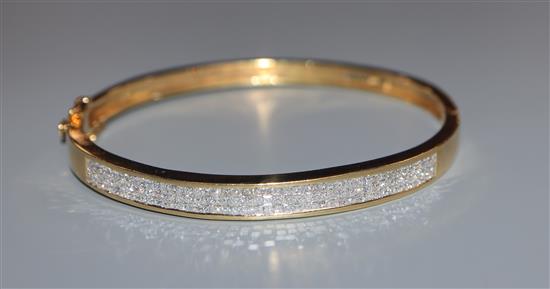 A modern 18k yellow metal and pave set diamond hinged bracelet.